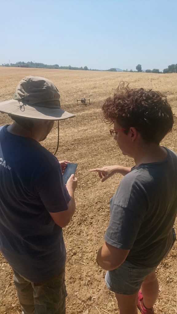 Picture of two researchers preparing the drone flight